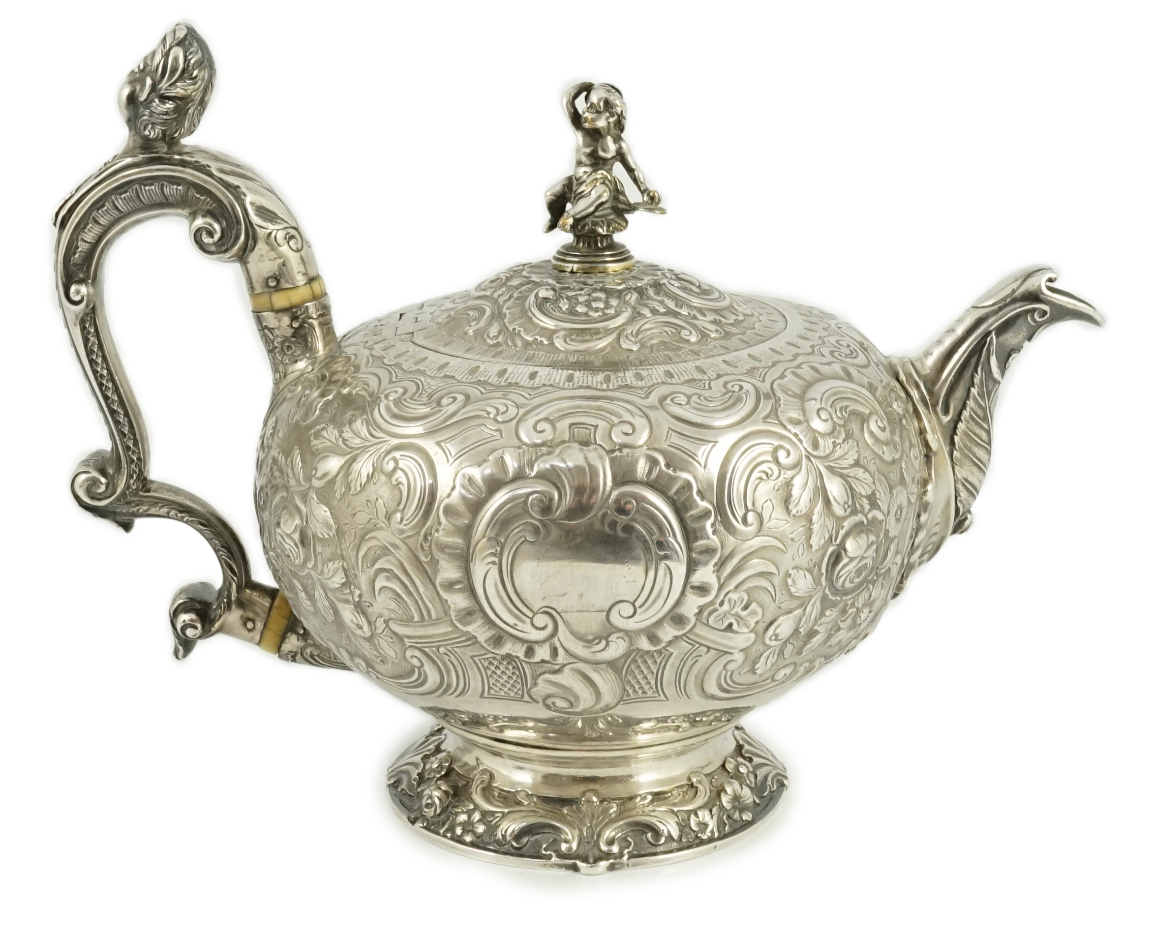 A George III silver rococo style inverted pear shaped pedestal teapot by Robert Garrard I